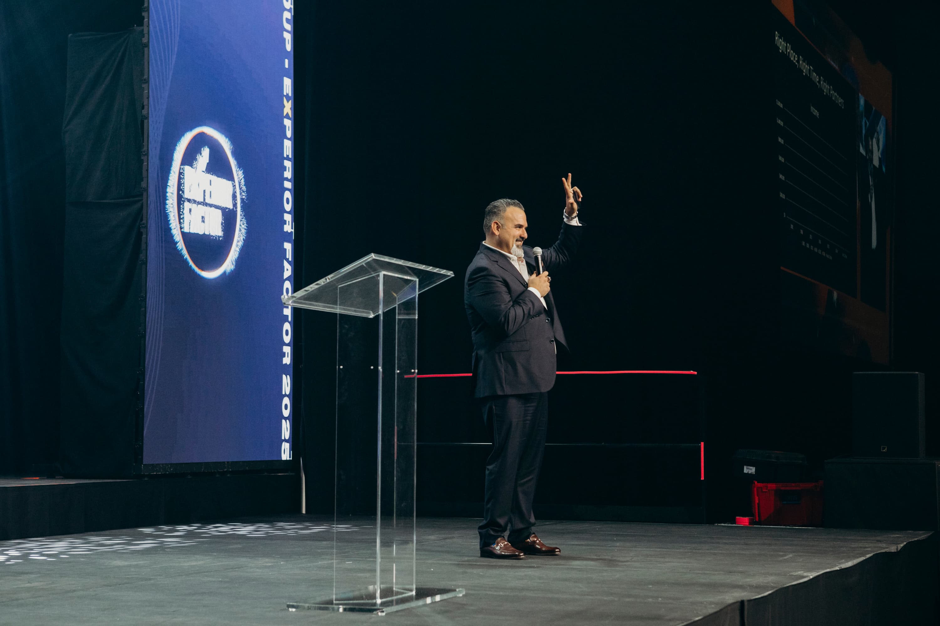 Frank Delio speaking beside a podium